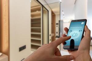 Mobile phone with app smarthome intelligent house automation remote control technology concept photo