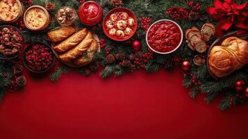 A festive Christmas spread featuring a variety of breads, dips, and desserts surrounded by holiday greenery and ornaments on a red background. photo
