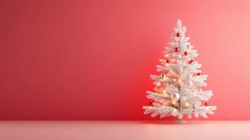 White Christmas tree with red and silver ornaments against a soft red background, creating a modern and festive holiday look. photo