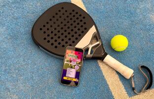 paddel racket and smartphone with bet background photo