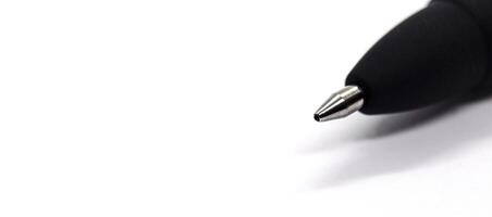 Top view of black pen on a wide white paper with customizable space for text or ideas. Copy space concept photo