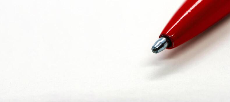 Top view of red pen on white paper with customizable space for text or ideas. Copy space concept photo