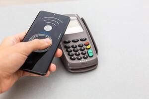 Man using technology on smart phone to pay bill photo
