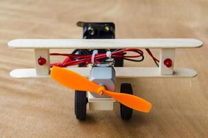 Front view of Do It Yourself toy airplane made by wooden sticks and DC motor. DIY concept photo