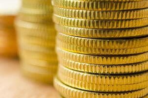 Side view of golden coins with customizable space for text. Business, banking and wealth concept photo