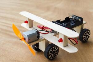 Do It Yourself toy airplane made by wooden sticks and DC motor. DIY concept. photo