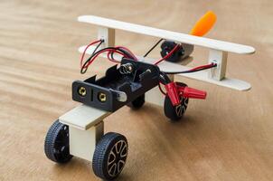 Back view of Do It Yourself toy airplane made by wooden sticks and DC motor. DIY concept. photo