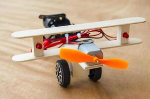Do It Yourself toy airplane made by wooden sticks and DC motor. DIY concept photo