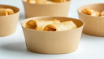 Spring roll crunchy fried snack on paper cup disposable container photo