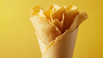Crapes flat bread crusty wrapped in waffle cone closeup solid background photo