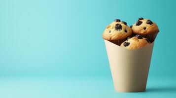 Muffin chocolate chips sweet crunchy snack dessert wrapped brown paper cone photo