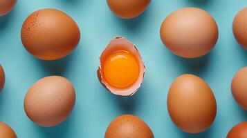 Egg pattern with a distinct anomaly of crushed shell showing egg yolk solid background photo