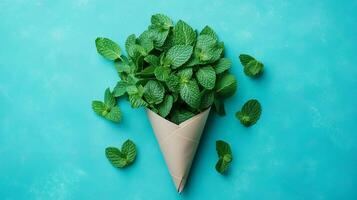 Mint green leaves on brown paper wrapped grocery delivery package with blue background photo
