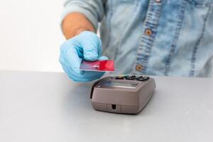 Payment on a trade through contactless card and NFC technology. Front view. Horizontal composition. photo