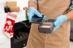 Payment on a trade through contactless card and NFC technology. Front view. Horizontal composition. photo