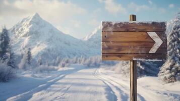Wooden brown plank sign in winter road guiding direction of destination photo
