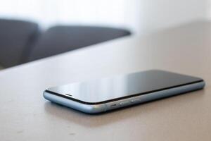 A single mobile phone on gray table photo