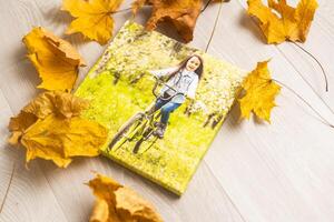 Blank square canvas frame on autumn background. Mockup poster with colourful autumn leaves photo