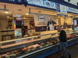 A clothing stall in a butcher's set up, Cork, Country Cork, Ireland on 16-09-2023 photo