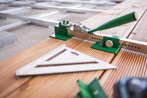 Tools Laid out on Wooden Planks During a Woodworking Project. Patio Flooring. photo