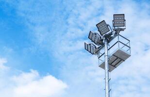 Bright Lighting Tower Stands Tall Against a Clear Blue Sky During the Day at an Outdoor Venue photo