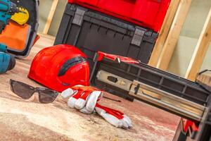 Essential Construction Gear and Tools Laid out on a Worksite Floor During a Renovation Project photo