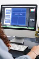 Close up of a person drawing up a design template on a computer. photo