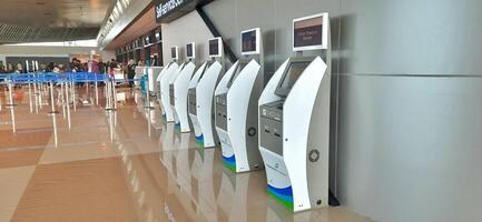Atmosphere and view of passengers activity at Sultan Hasanuddin International airport terminal. Makassar, South Sulawesi, Indonesia - September 7 2024 photo