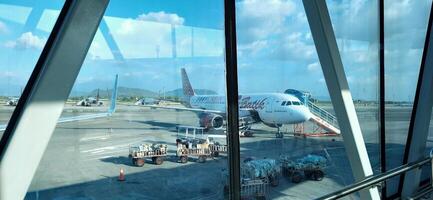 Atmosphere and view of passengers activity at Sultan Hasanuddin International airport terminal. Makassar, South Sulawesi, Indonesia - September 7 2024 photo