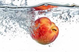 An apple is floating in water with bubbles photo
