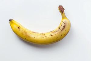 A banana is shown on a white surface photo