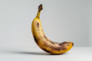 A banana with brown spots on it photo