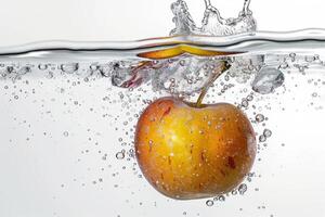 An apple is being splashed into water photo