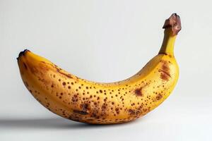 A banana with brown spots on it photo