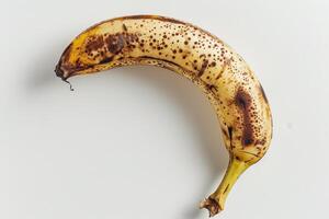 A banana with brown spots on it photo