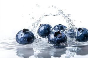 Blueberries are splashing into the water photo