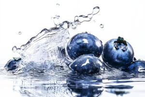 Blueberries splash in water on white background photo