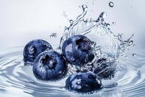 Blueberries are splashing into water photo