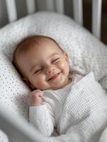 A baby is smiling in a crib photo