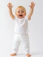 A baby in white pants and a white shirt photo