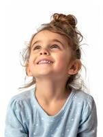A little girl is smiling and looking up photo