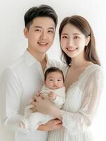 A couple holding their baby in a white background photo