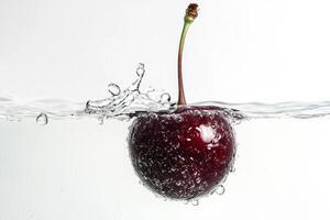 A cherry is falling into water with bubbles photo