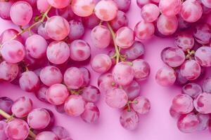 A bunch of grapes on a pink background photo