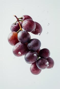 A bunch of grapes is floating in water photo