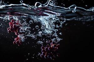 Water splashing grapes on black background photo