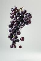 A bunch of grapes is falling to the ground photo