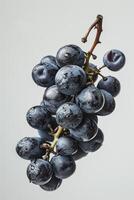 A bunch of grapes is shown on a white background photo