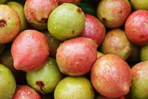 A pile of green and red fruits photo