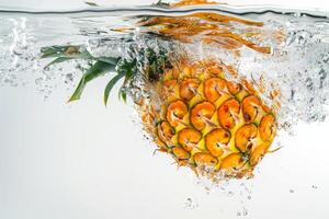A pineapple is being splashed into the water photo